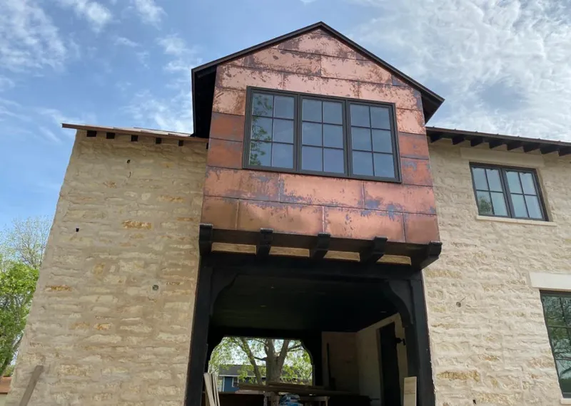 Copper metal panel facade on a stone building for Roof Repair in Fort Polk South